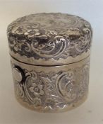 A heavy cylindrical embossed silver ink pot with s