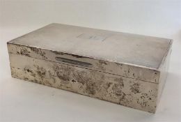 A rectangular engine turned silver cigarette case