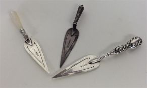 A group of three silver bookmarks in the form of t