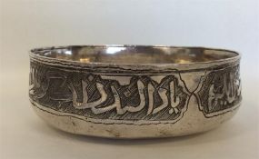 A heavy silver Islamic bowl, the rim decorated wit