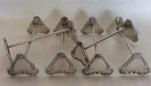 A heavy set of six Continental silver knife rests