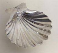 A Georgian silver butter shell with crested armori