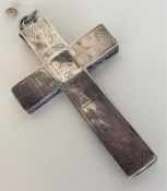 A large engraved crucifix heavily decorated with f