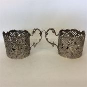 A pair of 800 Standard silver spirit cup holders p