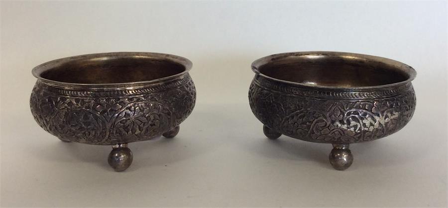 A heavy pair of Indian silver salts decorated with - Image 2 of 2