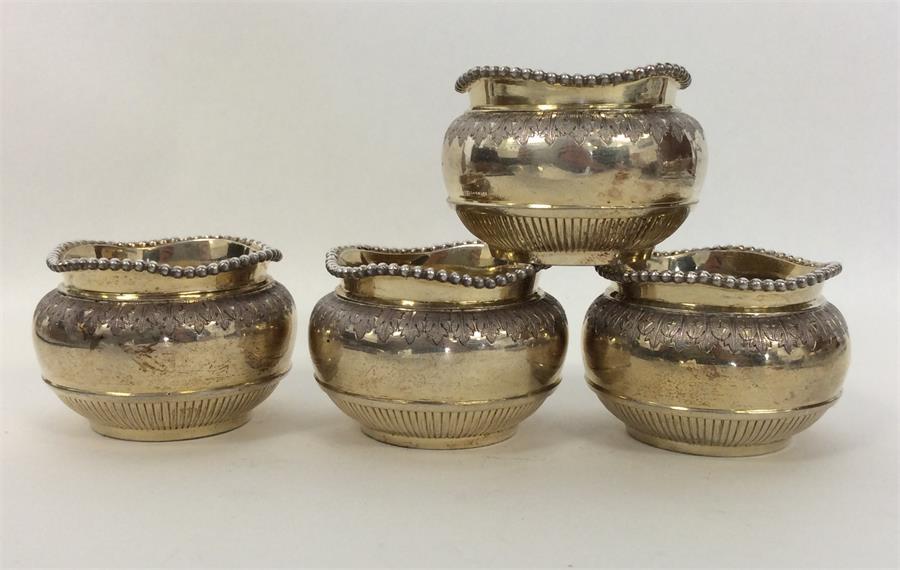 A good set of four silver gilt salts with beaded r