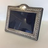 A modern rectangular silver picture frame with bea