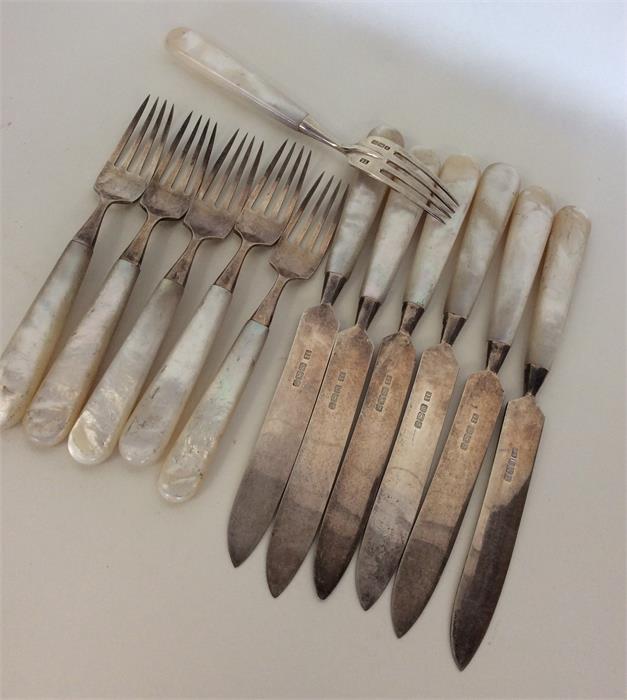 A set of 6 + 6 MOP dessert knives and forks with s