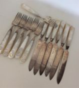A set of 6 + 6 MOP dessert knives and forks with s