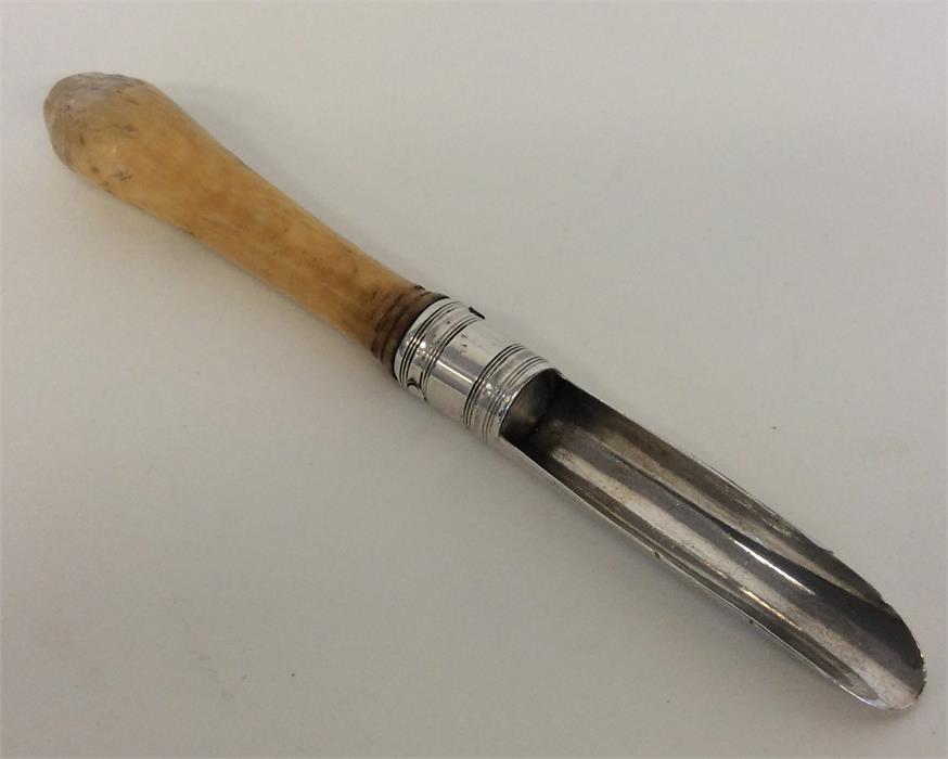 A Georgian bright cut silver apple corer on bone h