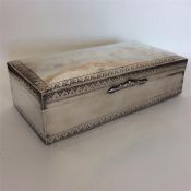 A heavy silver dome top cigarette box with engrave