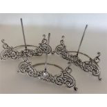 A set of three silver menu holders with scroll dec
