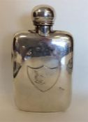 A large silver hip flask with screw-on lid. London