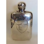 A large silver hip flask with screw-on lid. London