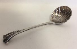 A Georgian silver sifter spoon with fluted bowl. A
