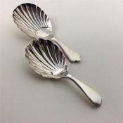 A heavy modern caddy spoon with fluted bowl and wa