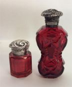 A silver mounted ruby glass scent bottle with embo