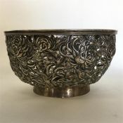 A heavy Chinese silver bowl decorated with flowers
