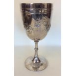A large Victorian goblet embossed with flowers and