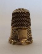 A small 15 carat gold thimble attractively decorat