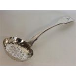 EXETER: A fiddle pattern silver sifter spoon with