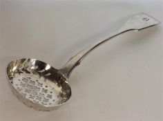 EXETER: A fiddle pattern silver sifter spoon with