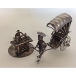 A Chinese silver miniature rickshaw together with