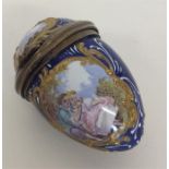 An enamelled scent bottle in the form of an egg de