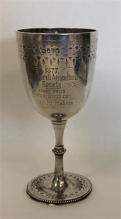 A Victorian silver goblet engraved with flowers an