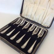A cased set of silver bead-edged cake forks. Sheff