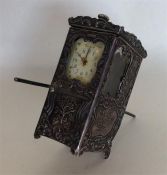 An unusual silver clock mounted as a Sudan chair d