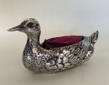 An unusual silver pin cushion in the form of a duc