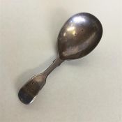 A large Georgian silver fiddle pattern caddy spoon