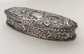 A silver boat-shaped embossed box with crimped edg