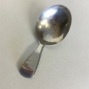 A Georgian silver bright cut caddy spoon with feat