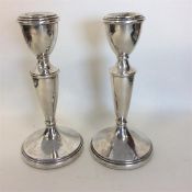 A pair of modern silver tapering candlesticks with