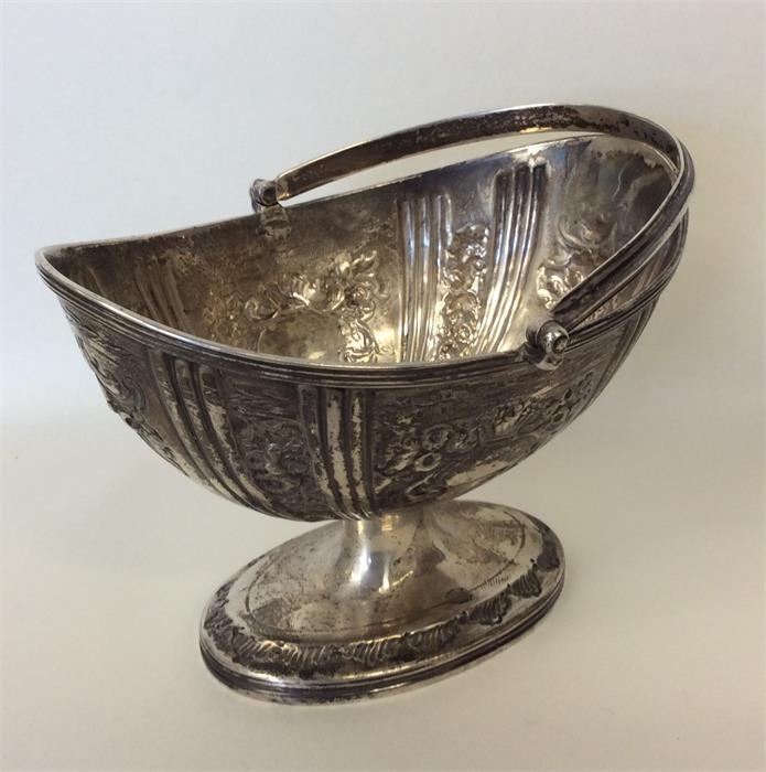 A Georgian silver embossed swing-handled basket wi - Image 2 of 2