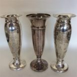 A pair of tapering silver spill vases together wit