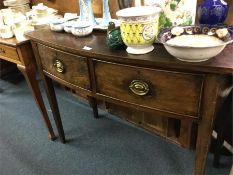 A mahogany bow front sideboard.