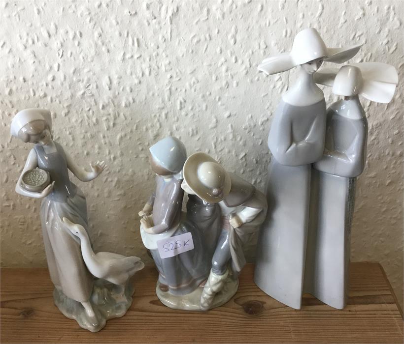 Lladro: A group of three figures.
