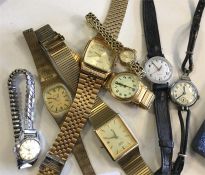 A group of modern gent's and ladies' wristwatches.