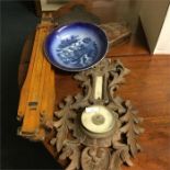 A mahogany carved barometer together with an easel