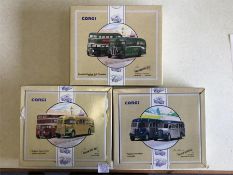 Three boxed Corgi buses.