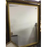 A massive gilt framed mirror.