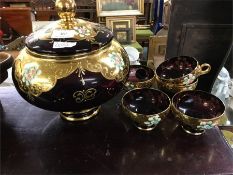 An amethyst glass punch bowl and glasses.