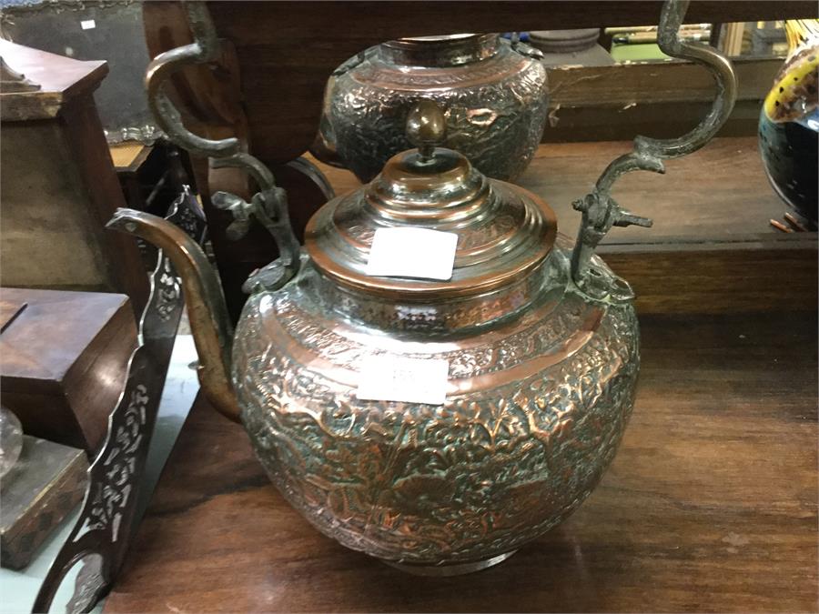 An old copper embossed kettle.