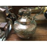 An old copper embossed kettle.