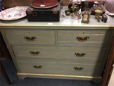 A painted chest of four drawers.