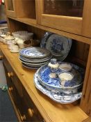 A quantity of blue and white plates together with
