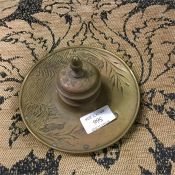 A brass inkstand decorated with flowers and birds.